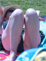 What is on my wife's as she lies in the sun?